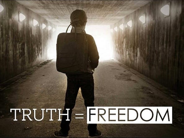 A person with a backpack stands in a dimly lit tunnel facing bright light, with the words "TRUTH = FREEDOM" in bold text at the bottom.